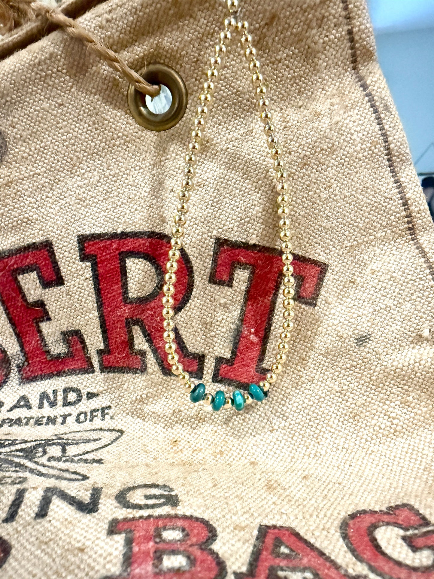 Necklace with blue beads on a textured background