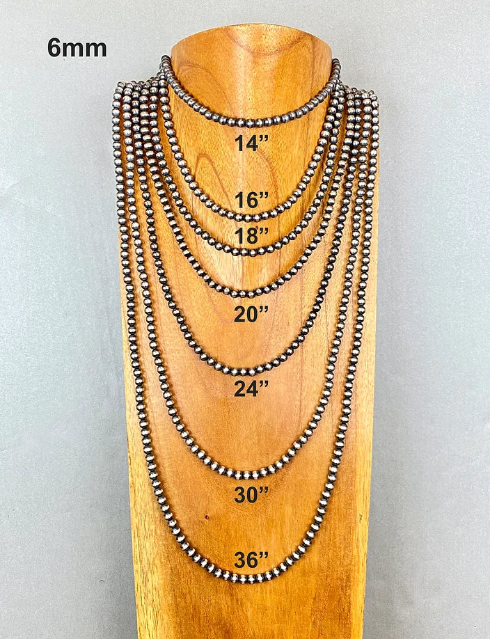 Set of sterling silver pearl beaded necklaces on a wooden mannequin with measurements displayed.