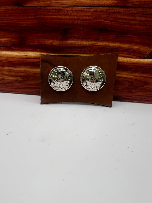 Silver round earrings on a brown rectangular card against a white background