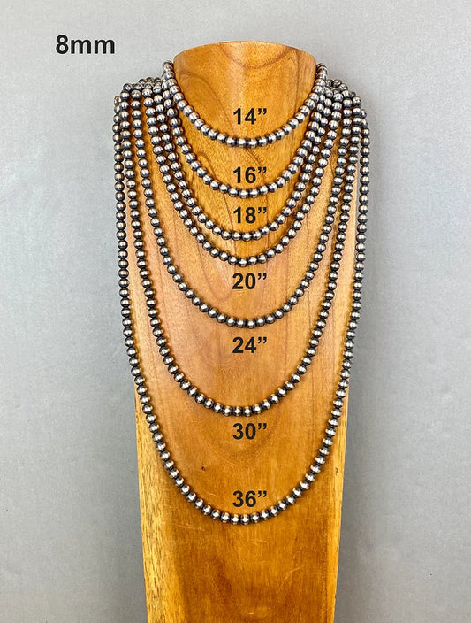 Set of beaded necklaces on a wooden stand with measurements indicated.