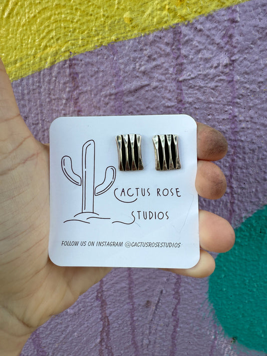sterling silver earrings on a colorful nackground
