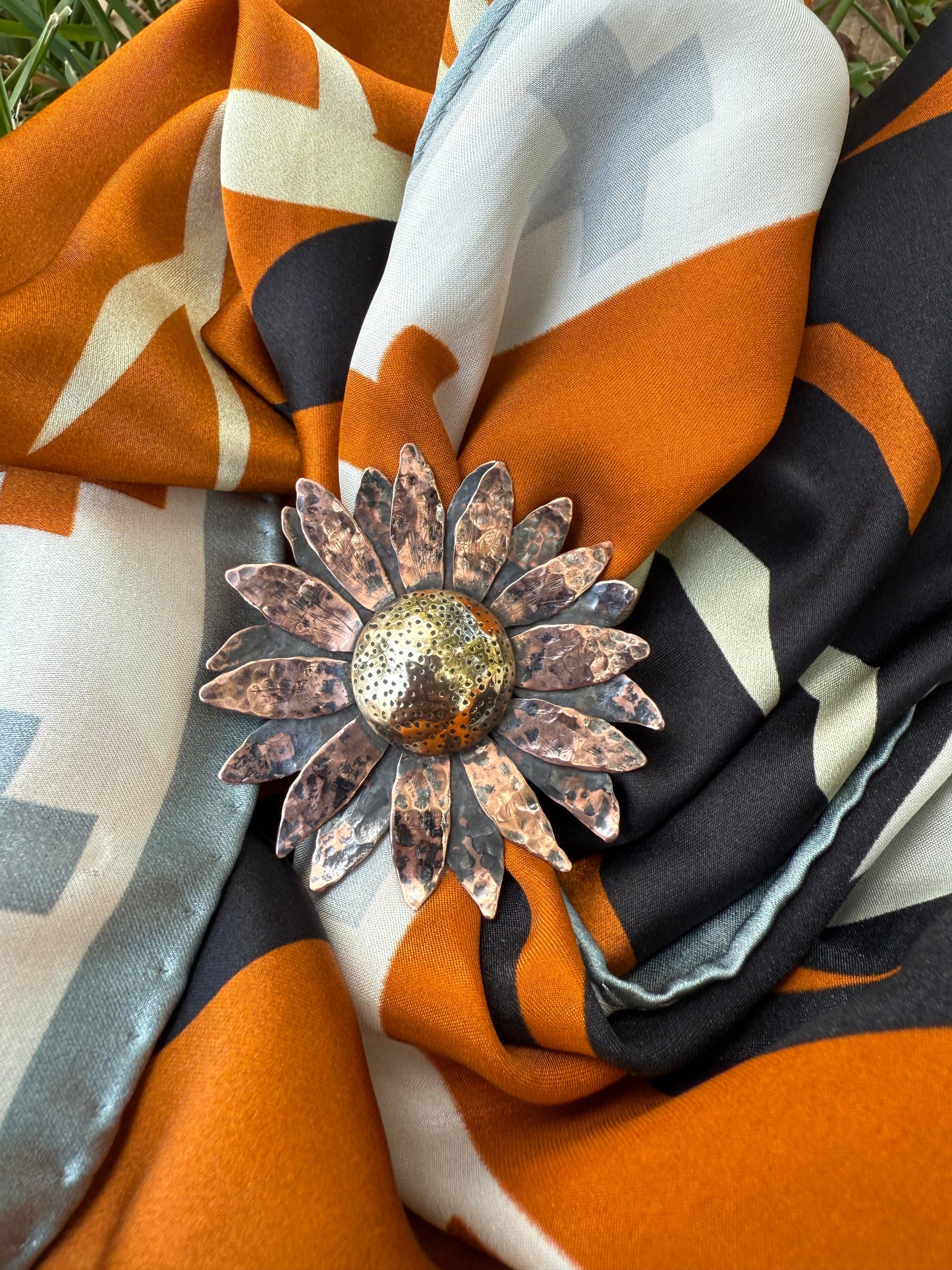 Decorative brooch on a colorful fabric background