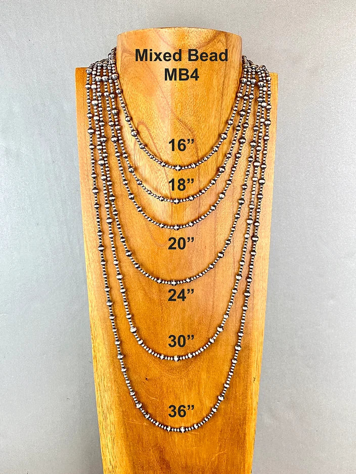 Wooden display with mixed bead necklaces of different lengths on a gray background